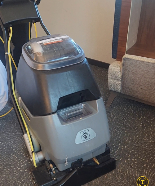 A floor scruber sitting on the floor of a hotel room