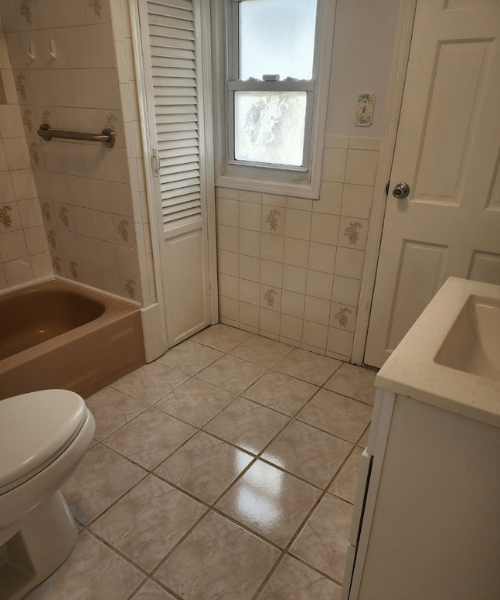 A bathroom with a toilet, sink, and bathtub