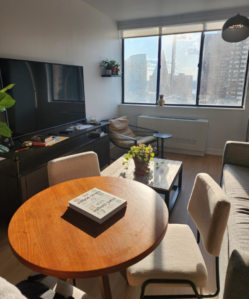 A living room with a table, couch and television